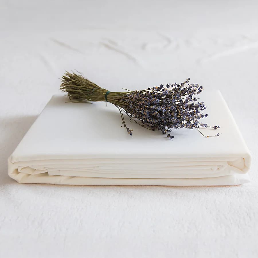 Some flowers laid on top of a pile of sheets